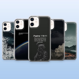 May include: A collection of five phone cases with various designs. One case features ocean waves, another has a space scene, and three others display Bible verses and a soldier image. The cases are clear with black and white graphics.