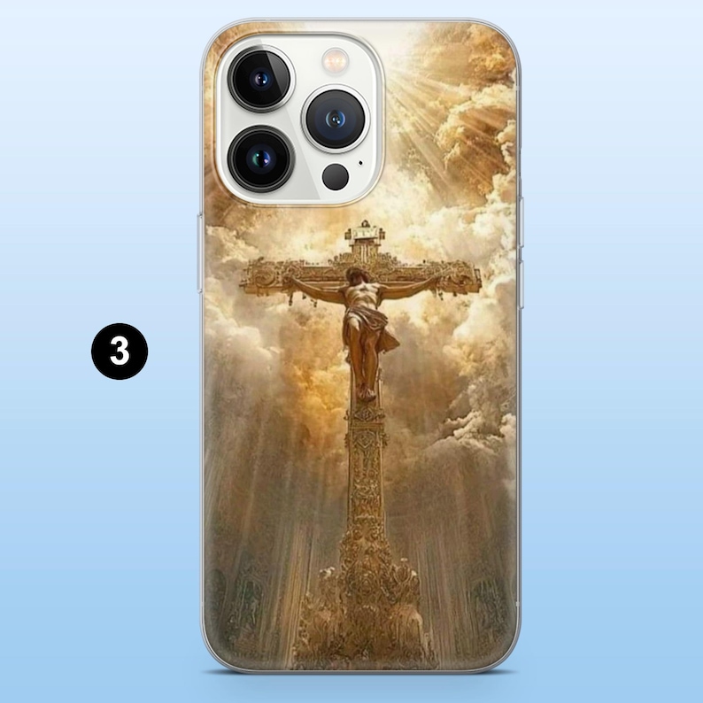 May include: A phone case featuring a religious image of Jesus on the cross. The artwork depicts a detailed crucifixion scene with a golden cross, a figure of Jesus, and a cloudy sky background. The case is designed to fit a smartphone.