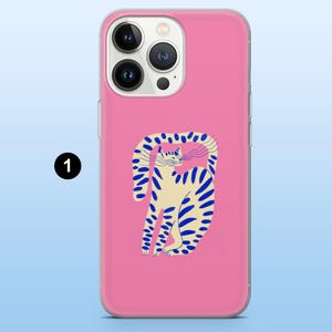 May include: A pink phone case featuring a whimsical illustration of a cat with blue stripes and a curved tail. The cat is set against a solid pink background. The case is designed to fit a smartphone.