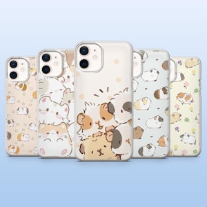 May include: A collection of five phone cases with various guinea pig designs. The cases feature illustrations of guinea pigs in different colors and poses, set against light-colored backgrounds. The cases are made of clear plastic.