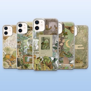 May include: Five phone cases with illustrations of frogs in different scenes. The cases have a vintage aesthetic with green, brown, and cream tones. Each case has a unique design, some incorporating text elements.