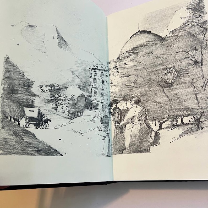 May include: A black and white sketch in a sketchbook depicts a mountain landscape with a building and figures. A horse-drawn carriage is on a road. The sketch style is detailed, with shading used to create depth and texture.