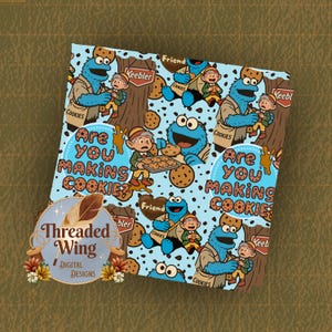 May include: A light blue fabric with a repeating pattern featuring the Cookie Monster, elves, and cookies. The text "Are You Making Cookies?" is visible, along with the "Threaded Wing Digital Designs" logo.