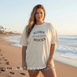 May include: A cream-colored t-shirt with the text "Aloha Mockup Studio Mocks" in black. The shirt is worn by a person on a beach. The words "Aloha Mocks Shop" are at the bottom of the image.