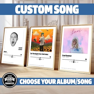 May include: Three framed prints of album covers with a white background and a black music player bar at the bottom. The album covers are for "Doors" by Mac Miller, "See You Again (Feat. Kali Uchis)" by Tyler, The Creator, and "Cruel Summer" by Taylor Swift. The text "CUSTOM SONG" is at the top of the image in blue letters. The text "CHOOSE YOUR ALBUM/SONG" is at the bottom of the image in blue letters.