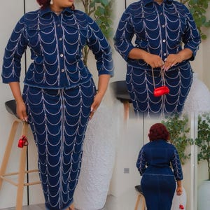 May include: A dark blue denim jacket and skirt set. The jacket has a collared neckline and long sleeves. The skirt is a pencil skirt. Both pieces are embellished with a white pearl design. The outfit is paired with red heels and a small red purse.