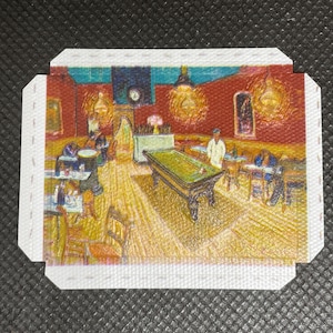 May include: A small, folded card displaying a painting of a billiards room. The artwork shows a green pool table, figures, and warm lighting. The walls are red, and the ceiling is blue. The card has a white border.