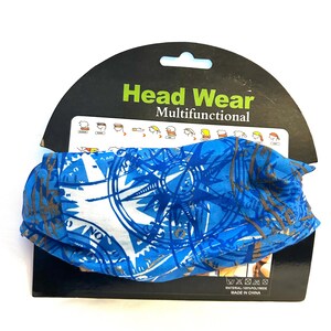 May include: Blue and white multifunctional headwear with a compass rose design. The headwear is made of 100% polyamide and is displayed on a black cardboard backing that reads "Head Wear Multifunctional".
