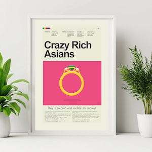 May include: A framed poster for the movie "Crazy Rich Asians" featuring a gold ring with a green gemstone on a pink background. The poster includes the movie title and a quote: "They're so posh and snobby, it's snoshy!"
