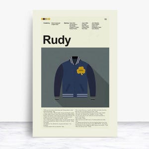 May include: Poster featuring the movie title "Rudy" in bold black letters. Below the title is a navy blue varsity jacket with gold shamrock and white stripes. The poster includes the names of the cast and crew.