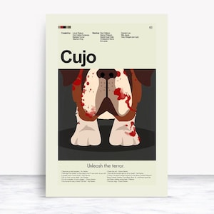 May include: A poster with the title "Cujo" features a stylized illustration of a Saint Bernard dog with blood splatters. The poster includes the text "Unleash the terror" and the names of the cast and crew.