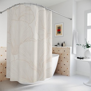 May include: A shower curtain featuring a large-scale, repeating line art pattern of beige ginkgo leaves on a white background. The curtain hangs from a curved metal rod and displays a fluid, organic design with fine, continuous lines.