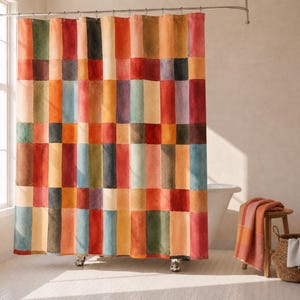 May include: A colorful shower curtain with a patchwork design. The curtain features a grid of rectangular blocks in various shades of red, orange, yellow, green, blue, and brown. The curtain is hanging in a bathroom with a white tub and a wooden stool.