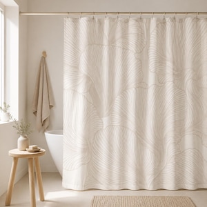 May include: A shower curtain featuring a large-scale, repeating pattern of abstract, flowing leaf-like shapes in a soft beige color against a cream-colored background. The design consists of fine, delicate lines that create a sense of movement.