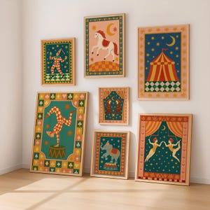 May include: A set of framed circus-themed art prints. The prints depict colourful illustrations of a horse, a clown, an elephant, a circus tent, and acrobats. The artwork is set against various backgrounds, including pink, teal, and navy blue.