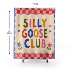 May include: A shower curtain featuring the text SILLY GOOSE CLUB in colorful letters on a cream background. It has a red and pink checkered border, blue wavy edges, and star and flower graphics. It measures 71 inches wide by 74 inches long.