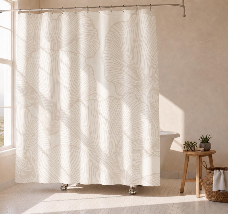 May include: A shower curtain featuring a large-scale, repeating line-art pattern of abstract, fan-shaped floral motifs in a soft beige color against a cream-colored background, suspended from a metal rod with integrated curtain rings.