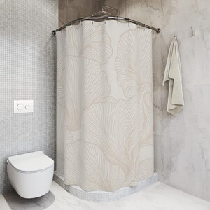 May include: A shower curtain featuring a repeating pattern of large, fan-shaped ginkgo leaves in soft beige and cream tones. The design consists of delicate, flowing lines that create a sense of movement across the fabric surface.
