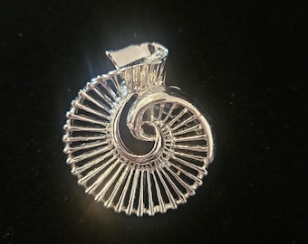 Vintage Gerry's silver-tone swirled, nautilus shell design brooch.