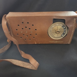 May include: A set of three ceramic mugs with a speckled, matte finish. The mugs are in shades of cream, light gray, and dark gray. Each mug has a simple, modern design and a comfortable handle.