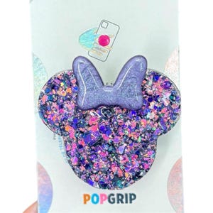 May include: Purple glitter phone grip with a purple bow in the shape of Mickey Mouse ears. The grip says "POPGRIP" at the bottom.