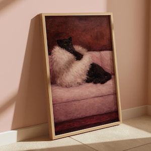 May include: A framed artwork shows a black panther lounging on a pink sofa, wearing a fluffy white fur. The panther looks at the viewer, set against a dark red background. The artwork is in a light-coloured wooden frame.