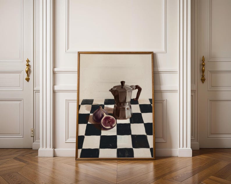 May include: A framed print featuring a still life composition. The artwork depicts a dark brown stovetop espresso maker, two figs, one sliced, on a black and white checkered tablecloth. The frame is a warm brown color.