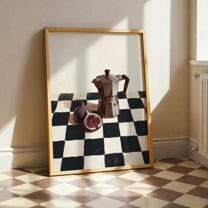 May include: A framed still life painting featuring a brown stovetop espresso maker, two figs, and a checkered black and white pattern. The figs are purple with a red interior. The frame is a light brown color.