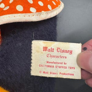 May include: A white tag with red text that reads "Walt Disney Characters Manufactured by California Stuffed Toys &copy; Walt Disney Productions".