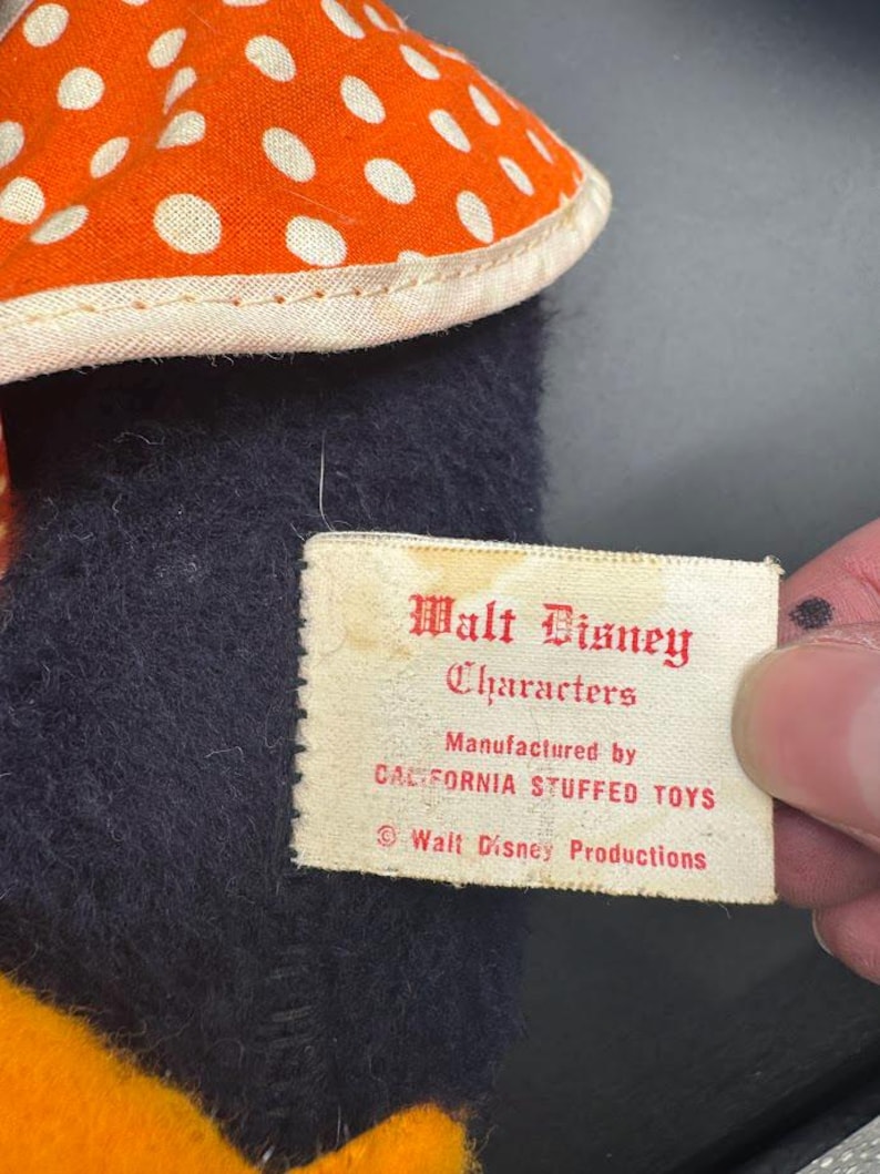 May include: A white tag with red text that reads "Walt Disney Characters Manufactured by California Stuffed Toys &copy; Walt Disney Productions".