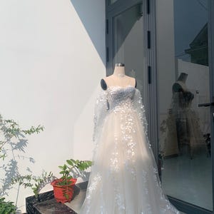 flower gown lace bridal dress boho lace wedding dress Embrace ethereal elegance with ourflower gown, a masterpiece for the free-spirited lace bridal dress 

Intricately designed to blend bohemian charm with timeless romance, boho lace wedding dress promises to make your special day unforgettable.