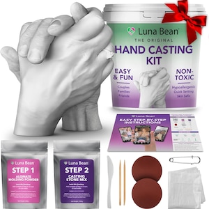 May include: A hand casting kit with a finished cast of two hands intertwined, one wearing a ring. The kit includes molding powder, casting stone mix, and instructions. The kit is labeled "Luna Bean Hand Casting Kit".