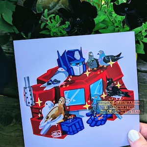 May include: A square art print featuring a colourful illustration of a blue and red robot head surrounded by several pigeons. The artwork includes small yellow star accents and the text ORIGINAL ILLUSTRATION BY NESSMADETHIS NO A.I. DO NOT STEAL.