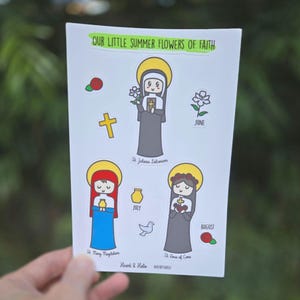May include: A set of colorful stickers featuring illustrations of saints with flowers and the months of June, July, and August. The text "Our Little Summer Flowers of Faith" is at the top of the sticker sheet.