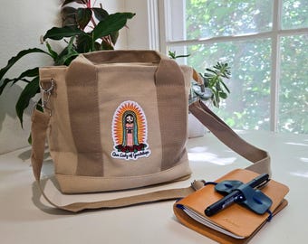 High Capacity Marian Crossbody Tote, Tan Canvas Travel Bag with Zipper, Embroidered Organizer Purse with Holy Trinity Design