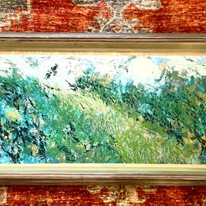May include: A framed abstract landscape painting with a green, blue, and white color scheme. The painting depicts a mountainous scene with brushstrokes that create a textured effect.