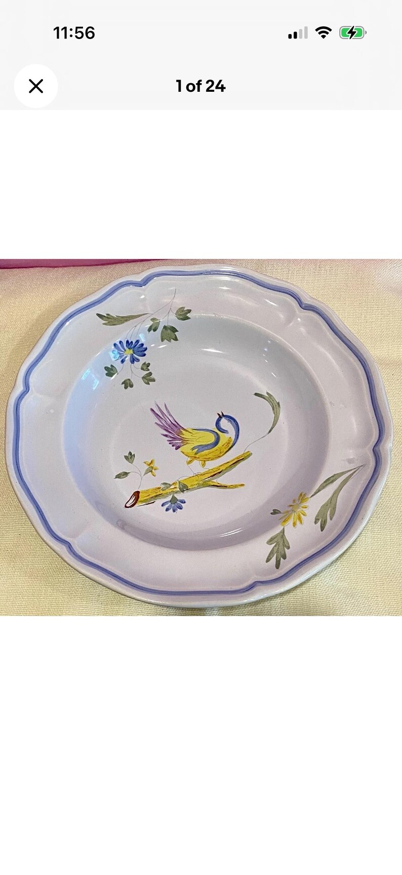 May include: White ceramic plate with a scalloped edge and a blue border. The plate features a hand-painted design of a yellow bird with purple and blue accents perched on a branch with flowers.