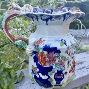 May include: A set of three ceramic mugs with a speckled, matte finish. The mugs are in shades of cream, light gray, and dark gray. Each mug has a simple, minimalist design, perfect for coffee or tea.