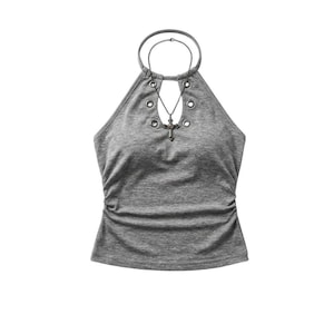 May include: A heather grey halter top featuring a high neckline with a circular ring detail, four silver-toned metal grommets, and side ruching. A thin silver-toned chain necklace with a cross pendant is draped through the top ring.