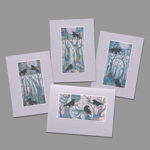 May include: Four framed prints of crow silhouettes in a blue and green forest setting. The crows are perched on branches and are surrounded by a variety of foliage.