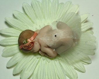 Miniature clay garden fairy baby-polymer clay fairy. This baby fairy can be used in a fairy house or a fairy garden or a shelf fairy