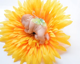 Miniature clay garden fairy baby can be used for a fairy garden or shelf fairy