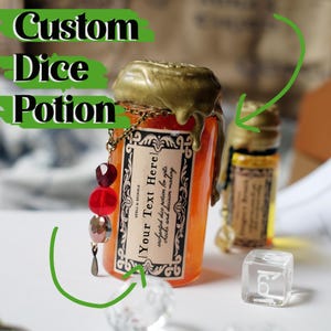 May include: An orange potion bottle with a gold wax seal and a decorative chain. The label reads "Your Text Here" and "enchanted dice potion for rolls, checks and decision making." The words "Custom Dice Potion" are at the top. A clear die is visible.