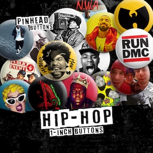 May include: A collection of 1-inch hip-hop buttons featuring images of artists and logos. The buttons display text such as "PINHEAD BUTTONS", "PUBLIC ENEMY", "RUN DMC", and "HIP-HOP". The buttons are round and have various colors.
