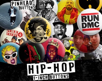May include: A selection of 2.5 cm hip-hop badges featuring images of artists and logos. The badges display text such as "PINHEAD BUTTONS", "PUBLIC ENEMY", "RUN DMC", and "HIP-HOP". The badges are round and have various colors.