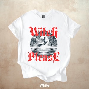 May include: White t-shirt with a graphic design featuring a witch on a broomstick inside a circle, with the words "Witch Please" in red gothic lettering. The shirt is made of a soft material and is suitable for casual wear.