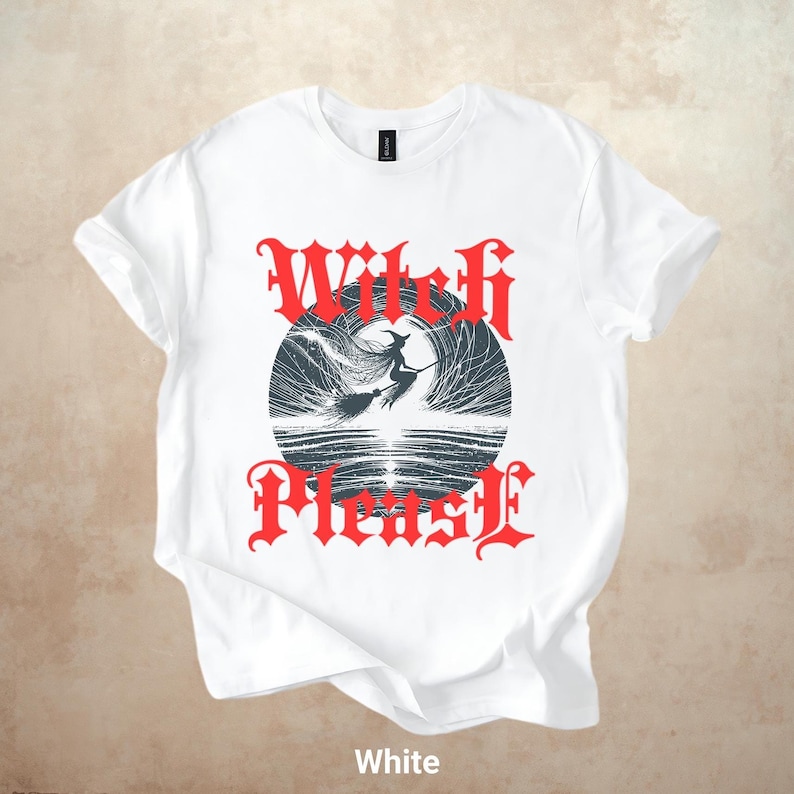 May include: White t-shirt with a graphic design featuring a witch on a broomstick inside a circle, with the words "Witch Please" in red gothic lettering. The shirt is made of a soft material and is suitable for casual wear.
