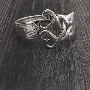 May include: A silver bracelet made from a repurposed spoon, featuring a heart-shaped design.