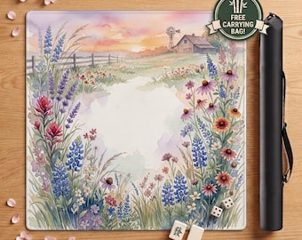 May include: A square playmat featuring a watercolor landscape of a field with wildflowers, a wooden barn, and a windmill under a sunset sky. The mat includes a black carrying case, two dice, and two mahjong tiles. A circular sticker reads FREE CARRYING BAG.