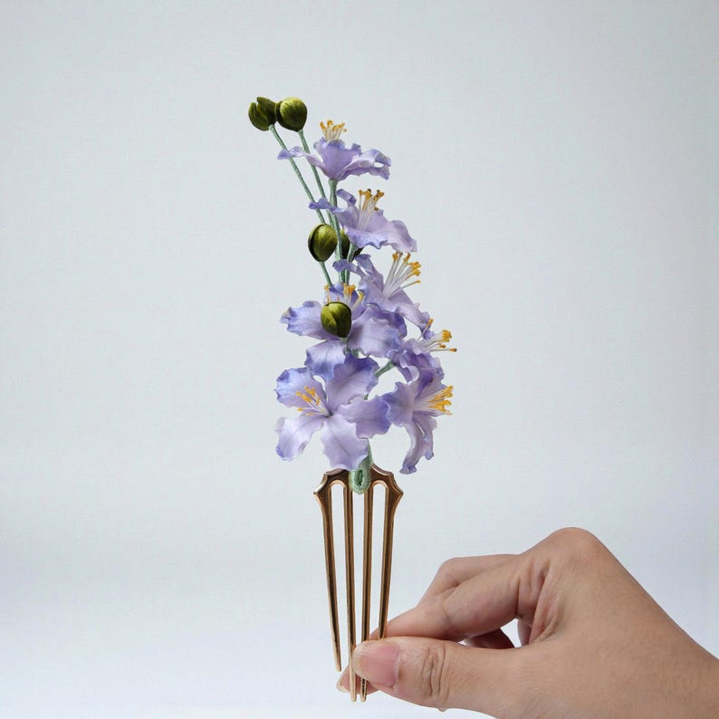 Purple mulberry silk velvet flower hair clip with green leaves. Handmade gradient violet floral headpiece with alligator clip for side hair. Detailed view of fuzzy texture.